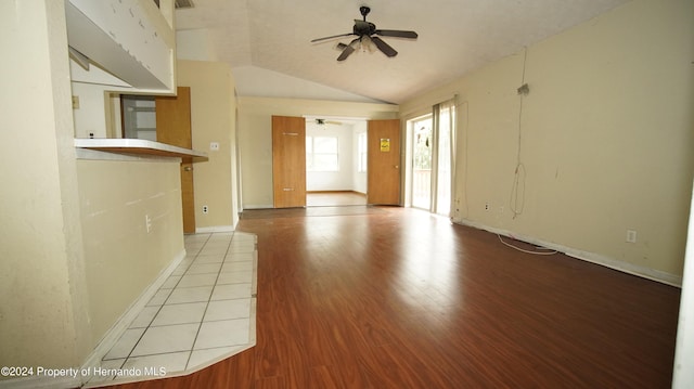 unfurnished room with light hardwood / wood-style floors, lofted ceiling, and ceiling fan