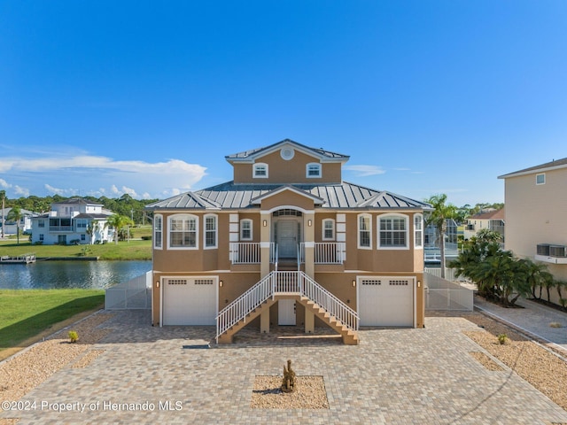 view of front facade featuring a water view and central AC