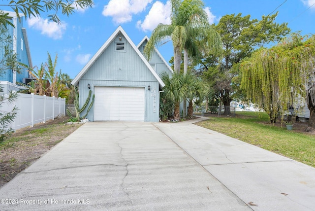 view of property exterior with a lawn and a garage