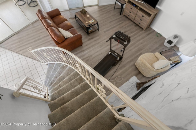 stairs with hardwood / wood-style floors