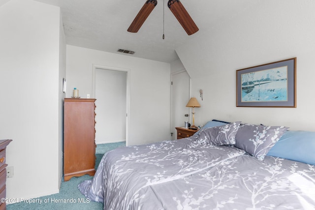 carpeted bedroom featuring ceiling fan, a textured ceiling, and vaulted ceiling