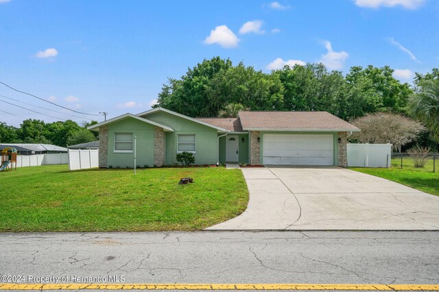 view of front of property with a garage and a front yard