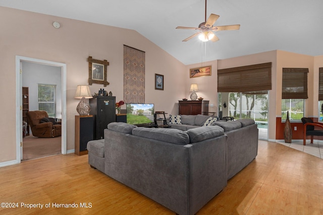 living room featuring light hardwood / wood-style floors, ceiling fan, and lofted ceiling