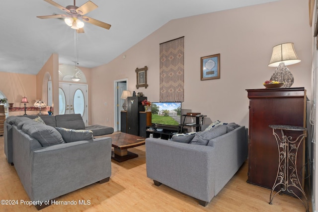 living room featuring light hardwood / wood-style floors, ceiling fan, and vaulted ceiling