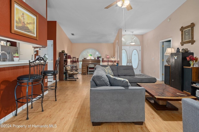 living room with light hardwood / wood-style floors and ceiling fan