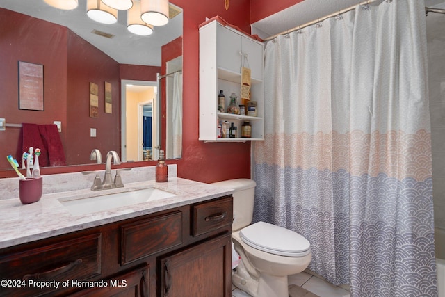 bathroom featuring toilet, vanity, and tile patterned floors