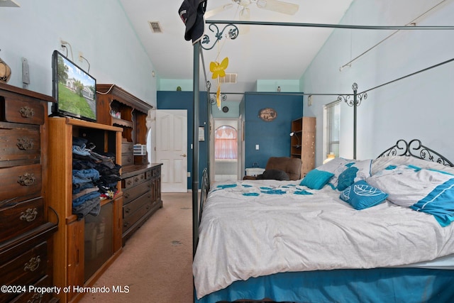 carpeted bedroom featuring lofted ceiling and ceiling fan