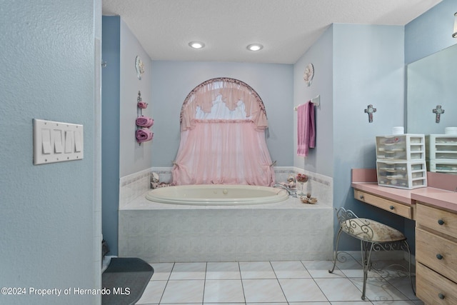 bathroom with vanity, tiled bath, and tile patterned flooring