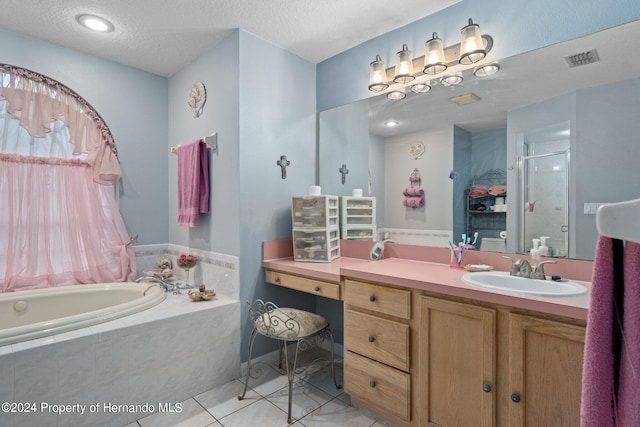 bathroom with vanity, a textured ceiling, tile patterned floors, and separate shower and tub