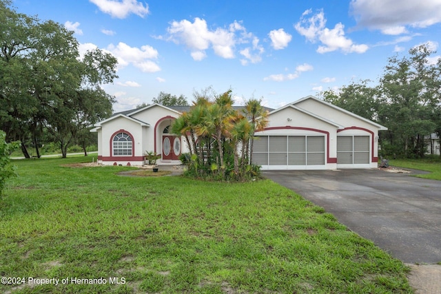 ranch-style house featuring a front yard and a garage