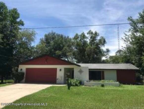 ranch-style house with a front lawn and a garage