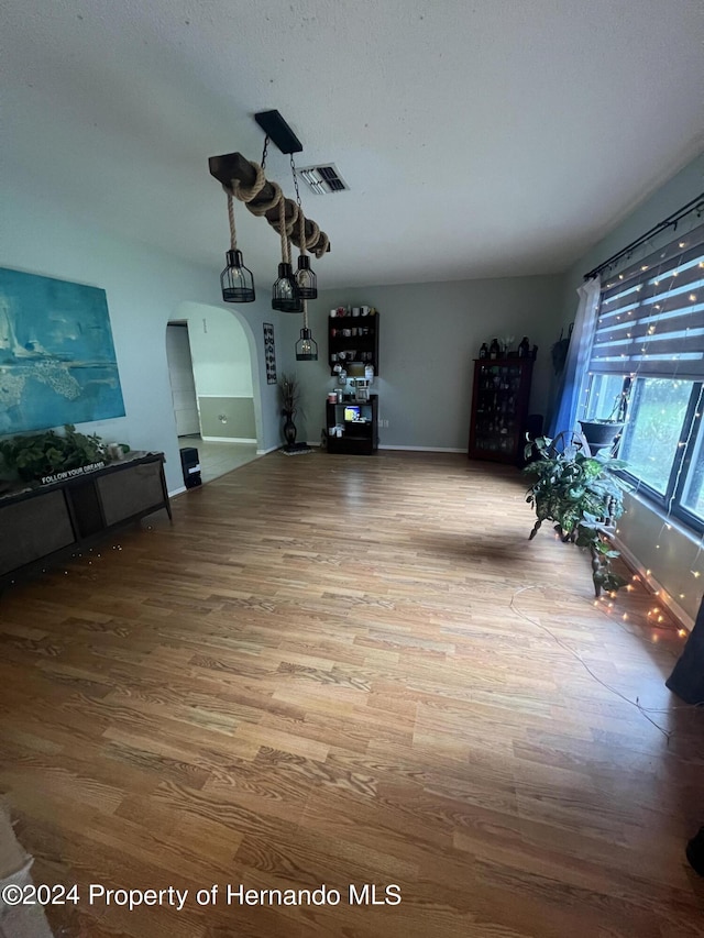 unfurnished living room with hardwood / wood-style flooring