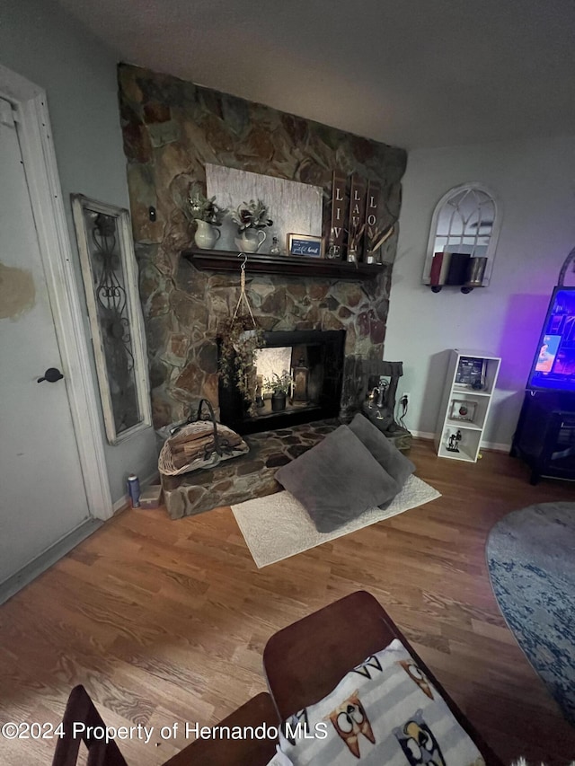 living room featuring wood-type flooring and a fireplace