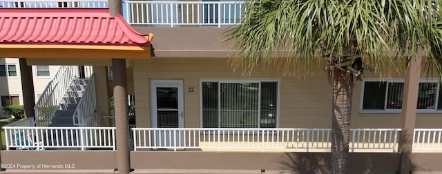 rear view of property with a balcony