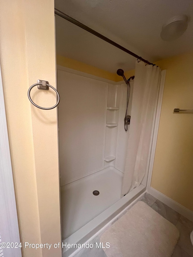 bathroom featuring tile patterned floors and a shower with curtain