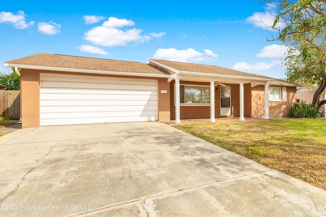 ranch-style home with a front lawn and a garage