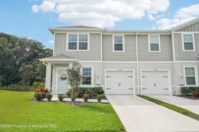 view of front of home with a garage and a front lawn