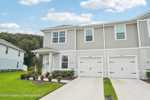 view of front of property featuring a garage and a front lawn