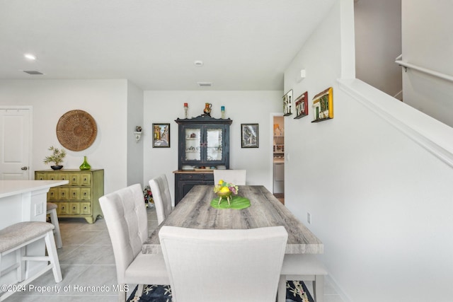 dining space featuring light tile patterned flooring