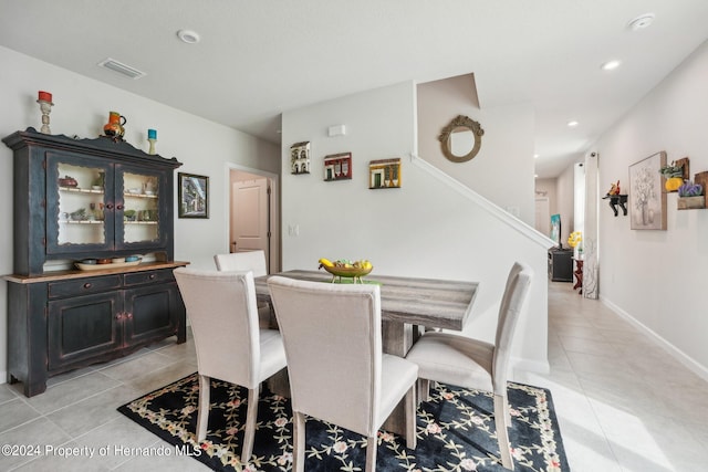 dining space featuring light tile patterned flooring