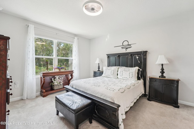 bedroom featuring light colored carpet