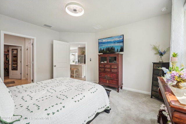 bedroom with light carpet and stainless steel fridge with ice dispenser