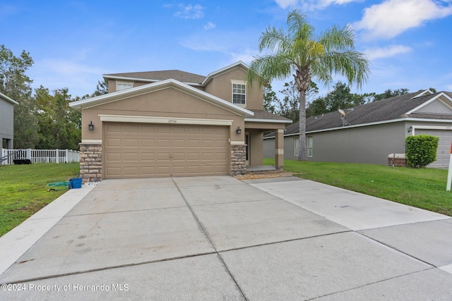 view of front of home featuring a front yard and a garage