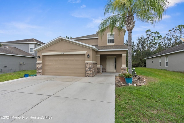 view of front of property with a front lawn and a garage