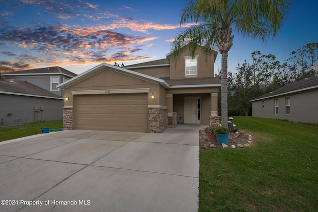 view of front of property with a lawn and a garage