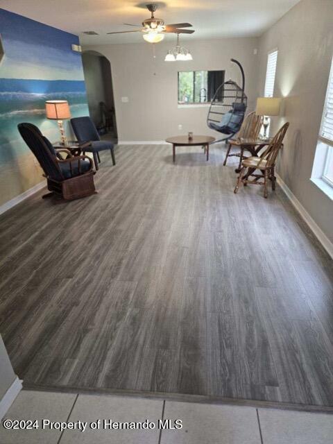 unfurnished room with ceiling fan and dark wood-type flooring