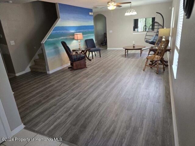 living area featuring hardwood / wood-style flooring and ceiling fan