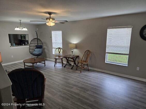 sitting room featuring ceiling fan and dark hardwood / wood-style floors