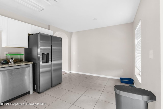 kitchen with white cabinetry, plenty of natural light, light tile patterned floors, and appliances with stainless steel finishes