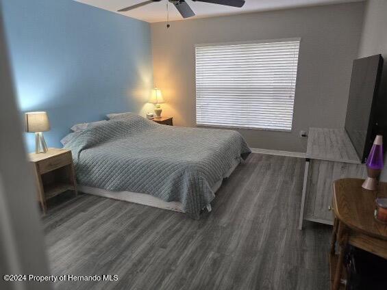 bedroom featuring dark hardwood / wood-style flooring and ceiling fan