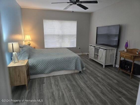 bedroom featuring ceiling fan and dark hardwood / wood-style flooring