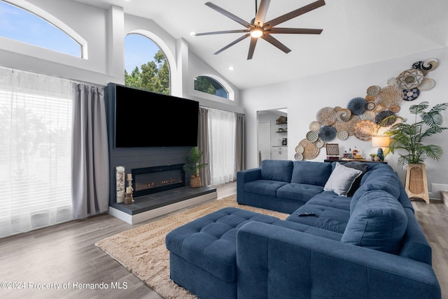 living room featuring high vaulted ceiling, hardwood / wood-style floors, and ceiling fan