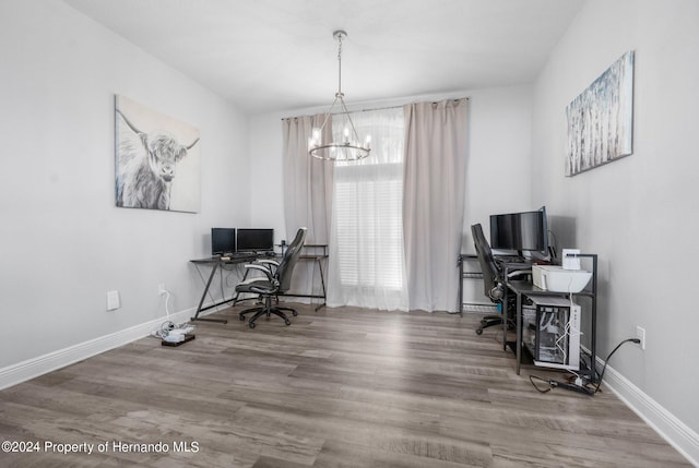 office featuring wood-type flooring and a notable chandelier