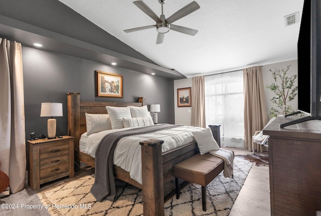 bedroom with light wood-type flooring, lofted ceiling, and ceiling fan