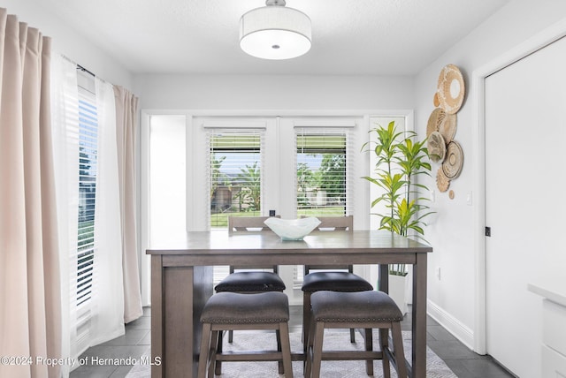 tiled office space featuring french doors and a textured ceiling