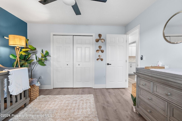 bedroom with ceiling fan, a closet, and light wood-type flooring