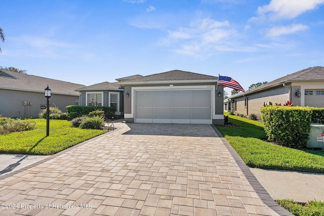 single story home with a garage and a front yard