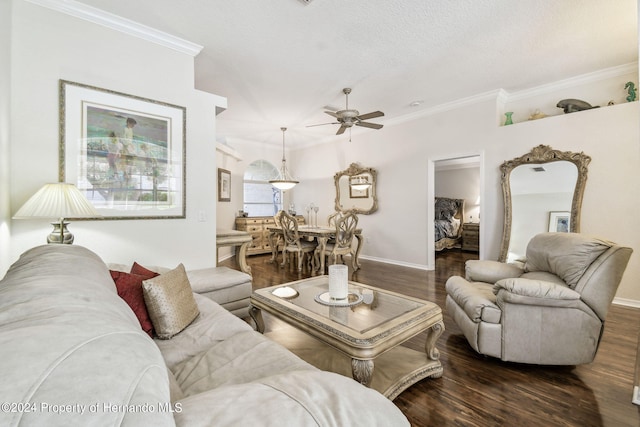 living room featuring ceiling fan, dark hardwood / wood-style floors, and crown molding