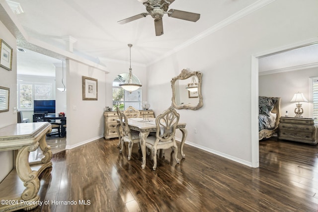 dining room with dark hardwood / wood-style floors, a healthy amount of sunlight, and ornamental molding