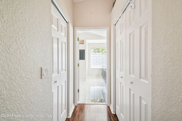 corridor with dark hardwood / wood-style flooring