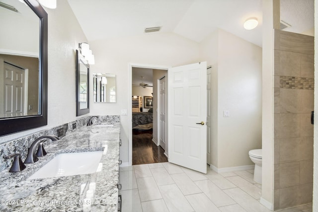 bathroom featuring tile patterned floors, vanity, toilet, lofted ceiling, and ceiling fan