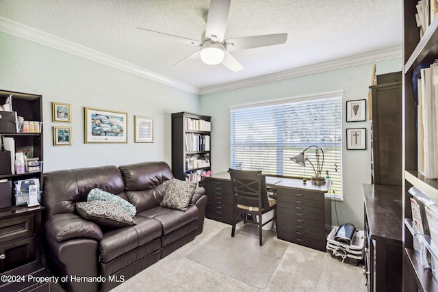 home office featuring ceiling fan, a textured ceiling, crown molding, and carpet floors