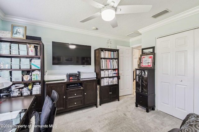 carpeted home office featuring ceiling fan, a textured ceiling, and crown molding