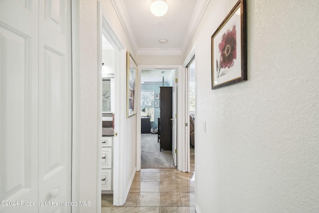 corridor featuring light colored carpet and crown molding