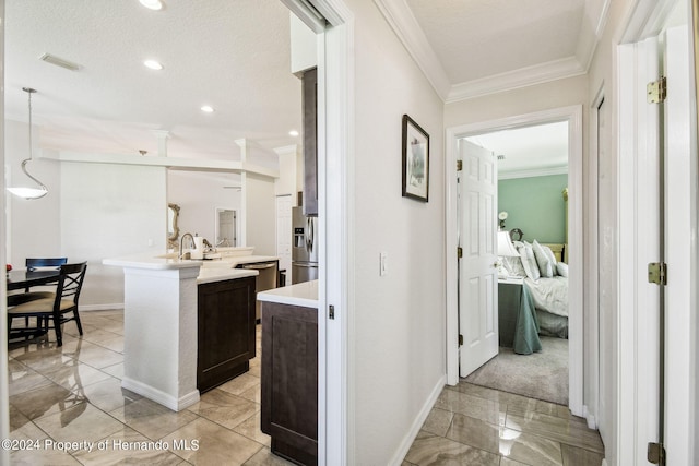 hall featuring a textured ceiling and ornamental molding