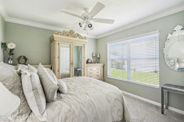 carpeted bedroom with ornamental molding, a textured ceiling, and ceiling fan